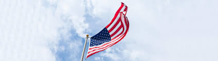 US flag waiving in front of clouds